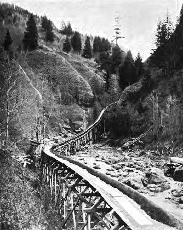 A half mile flume in the forest. The flume is a raised channel built to transport logs or timber.