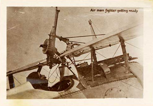 Aviator sitting in cockpit of airplane.