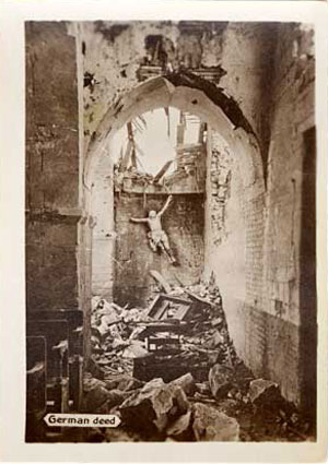 Looking into a ruined chruch with a carving of Jesus askew on the back wall.