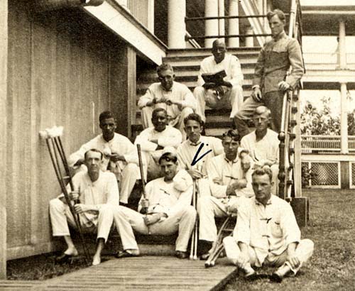 Eleven men, including Ralph Boyer, sit on steps at a rehabilitation center.