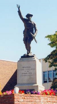 Yamhill County grounds with "Doughboy" statue surrounded by flowers at base.