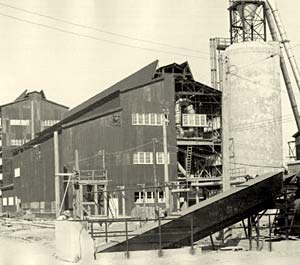 Photo of 6 story building with scaffolding, pipes & ramps set up around the outside.