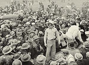 Photo of a crowd of about 100 people standing around smiling and talking.