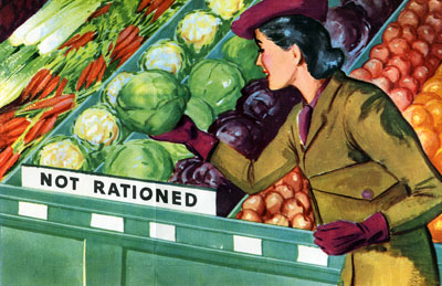 Woman in the fresh produce section picking up a cauliflower from a section with a sign reading "Not Rationed."