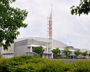 Building with metal tower in front with "EXPO" printed.