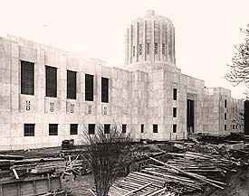 Front of Capitol building with construction material laying on the ground.