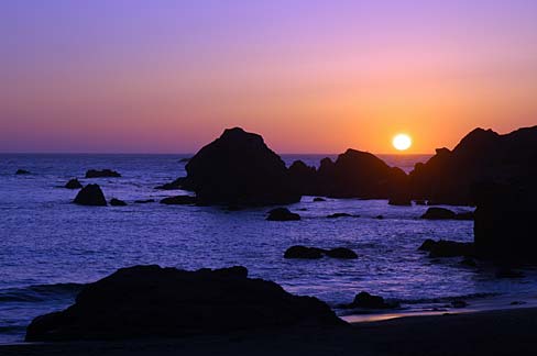 Rocky beach line with sunset.