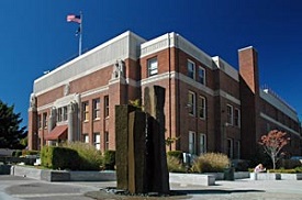 Brick county courthouse with flag flying on top.