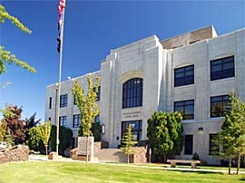 Three story square building looks like it's made from white marble.