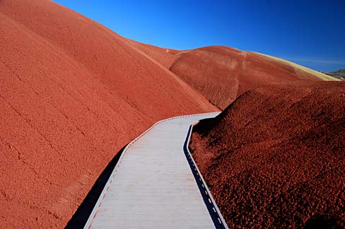 Red rocked rolling hills with a boardwalk through the valley section.