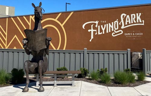 A statue of a horse in front of a building.