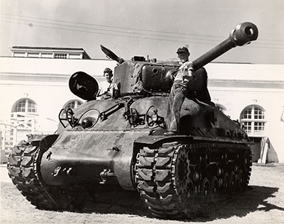 Boys play on a tank
