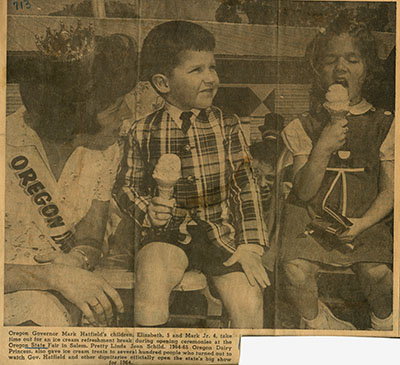 A boy and girl eat ice cream cones