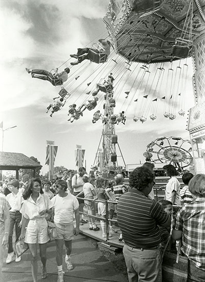 Fairgoers ride the swing ride