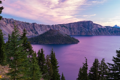 A lake in the crater of a dormant volcano. There is an island in the center of the lake.