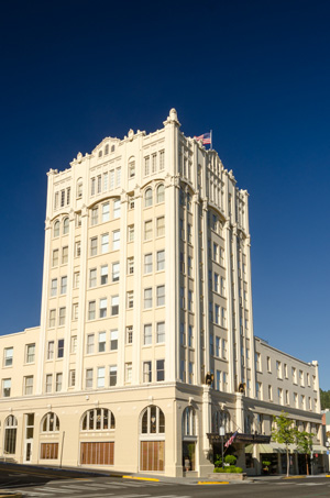 A 9 story hotel with flag flying on top takes up a city block.