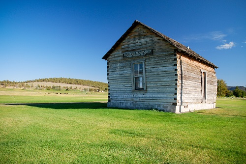 The Nichols Cabin is an example of an early quared log structure. On the 2 sides visible is a door and a window.