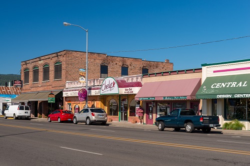 Businesses such as "Central Point Design Center" line a 4 lane road with on-street parking in Central Point.