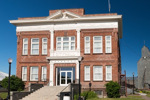 Two-story, colonial revival brick structure with stone foundation.