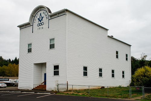 Wood builiding, 3 stories high with Lodge emblem on front and the year 1916.