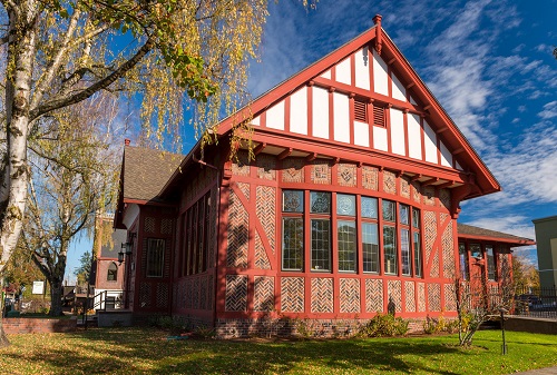 Building in the English Tudor Revival style. Originally Gresham's 1st public library. It features herringbone brickwork and leaded glass windows.