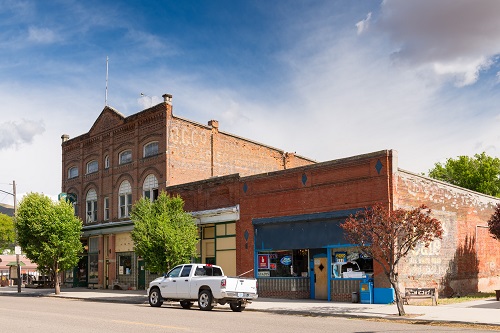 Historic commercial building in the High Victorian Italianate architectural style. Brick walls, stone foundation, flat roof.