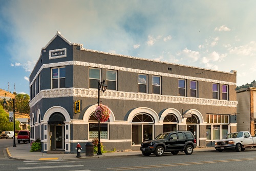 2-story building in downtown John Day at the corner of SE Dayton St. & the John Day Hwy. A sign at top says "Bank 1904."