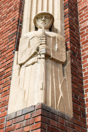 World War I soldier in stone graces the corner of this art deco brick building.