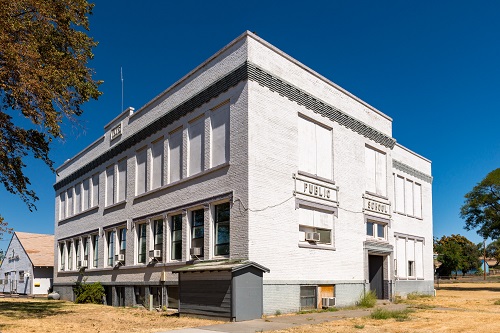 Building's exteriror reflects 20th century American Movements styles. Concrete foundation, brick & Stucco walls, 3-story. 