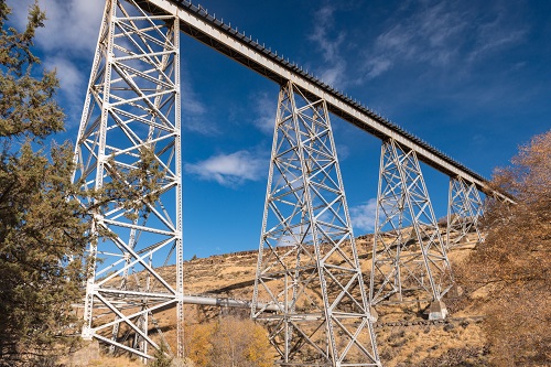 Deck plate girder bridge over Willow Creek on as seen from below looking up.