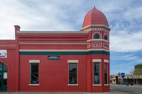 One-story rectangular building. It has a polygonal tower bay at the northeast corner. Exterior walls are brick as is foundation.