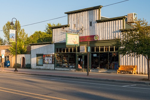 Street view of David Hamilton wine shop. A square sign hangs out perpendicular to the building & says "Fruit Wine"