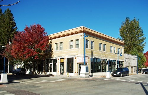 Two-story commercial building on corner of city street. 