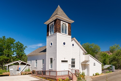 Single-story building with taller, 2 or 3 story tower in front.