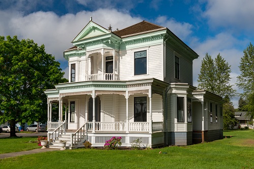 Queen Anne Style house. Stone foundation, wood walls, shingle roof. Two-story wood structure built in 1902-03.  The asymmetrical structure dominates a corner lot with a wrap-around porch and ornamental gabled dormer with bell shaped walls and patterned shingles decorating roof.