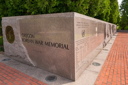 A 109-foot long granite wall with the names of Oreonians who died or listed missing in the war. The path in front is brick.