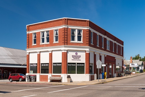 two-story brick building takes up most of the block.