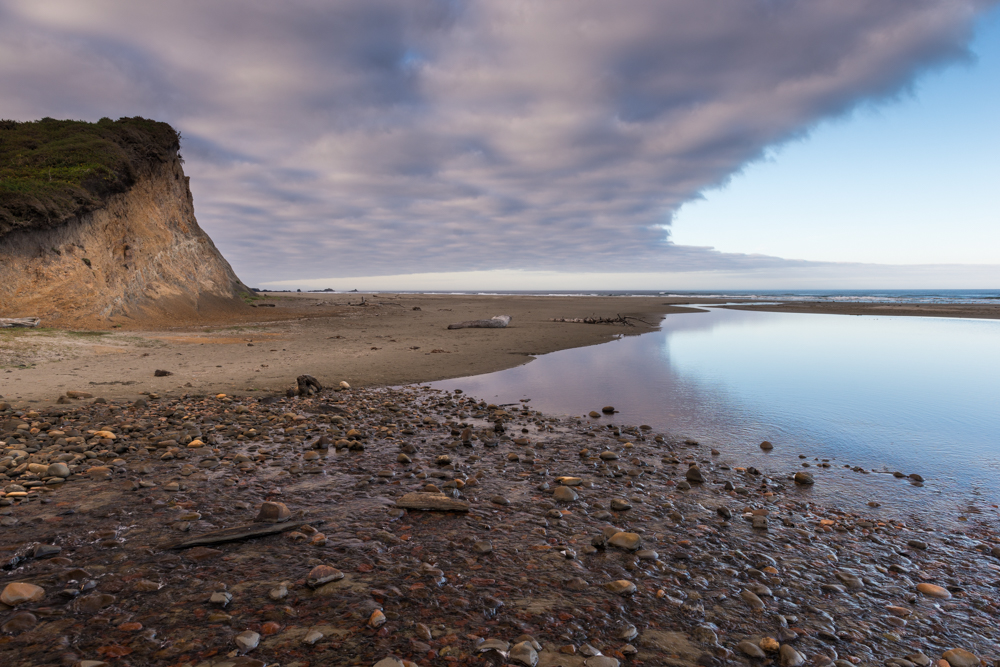 rocky beach and dark clouds overhead