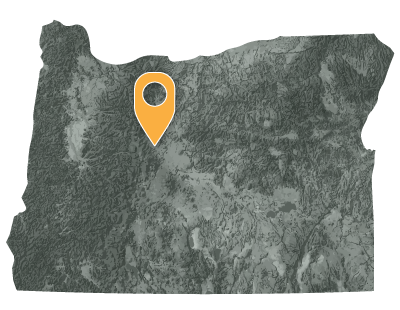 Oregon map with black and white circles documenting location of the confederated tribes of Warm Springs