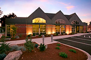 Office building with parking spots in front.