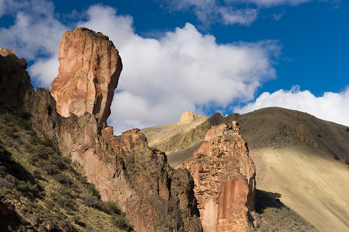 rock formations with blue sky and clouds behind